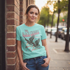 WOMAN WEARING Light blue t-shirt with 'The Black Crowes' graphic design  BCR516-PBLHTS, BCR516-PBLHTM, BCR516-PBLHTL, BCR516-PBLHTXL, BCR516-PBLHTXXL