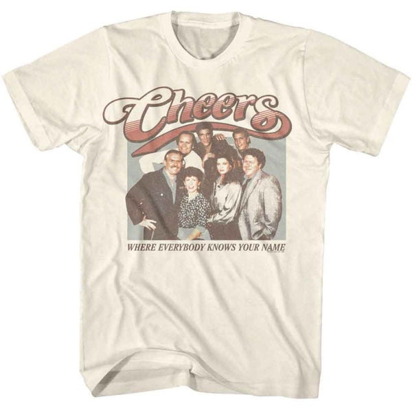 Beige t-shirt with 'Cheers' graphic featuring characters and text on a white background