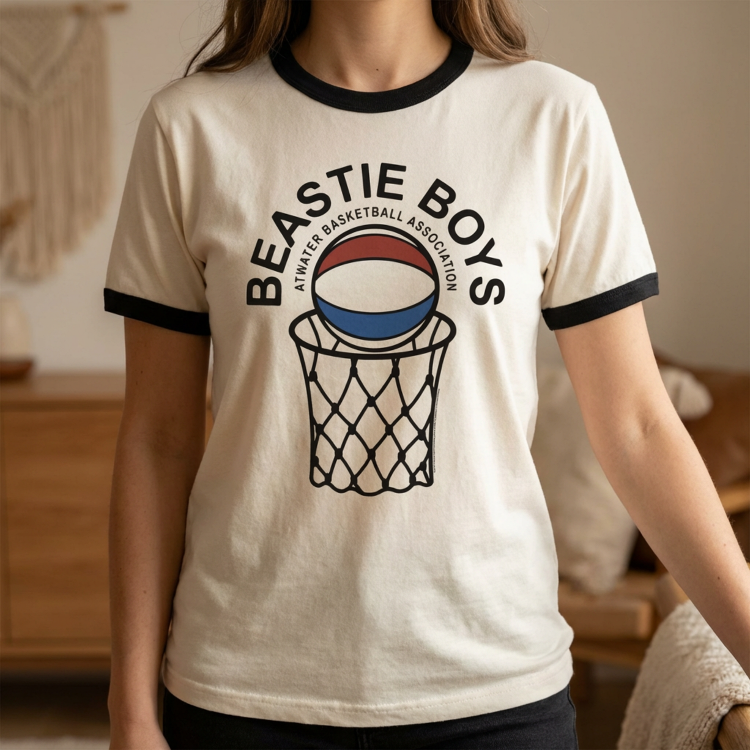 Person wearing a white t-shirt with 'Beastie Boys' and basketball design. BBS513-211S, BBS513-211M, BBS513-211L, BBS513-211XL, BBS513-211XXL