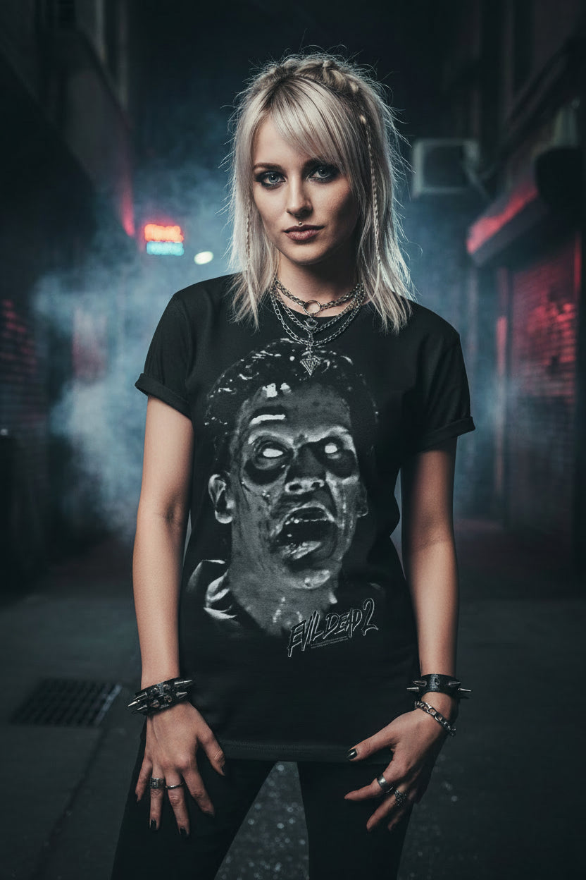 woman wearing Black t-shirt with a graphic of a zombie face and ' Evil Dead 2' text EVLD530S, EVLD530M, EVLD530L, EVLD530XL, EVLD530XXL