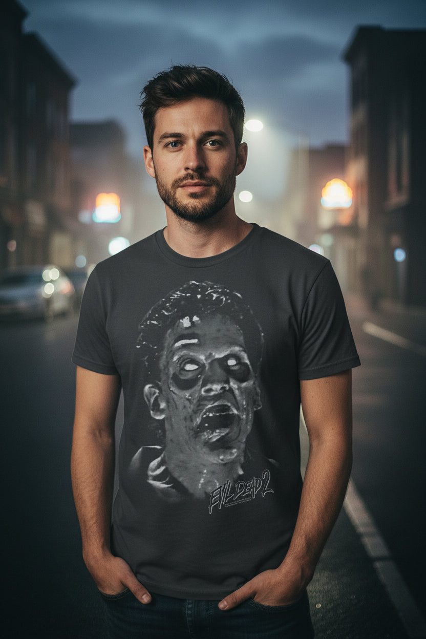 man wearing Black t-shirt with a graphic of a zombie face and ' Evil Dead 2' text EVLD530S, EVLD530M, EVLD530L, EVLD530XL, EVLD530XXL