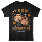 Black hunger games t-shirt with 'Team District 12' design featuring two characters and hearts, inspired by 'The Hunger Games'.