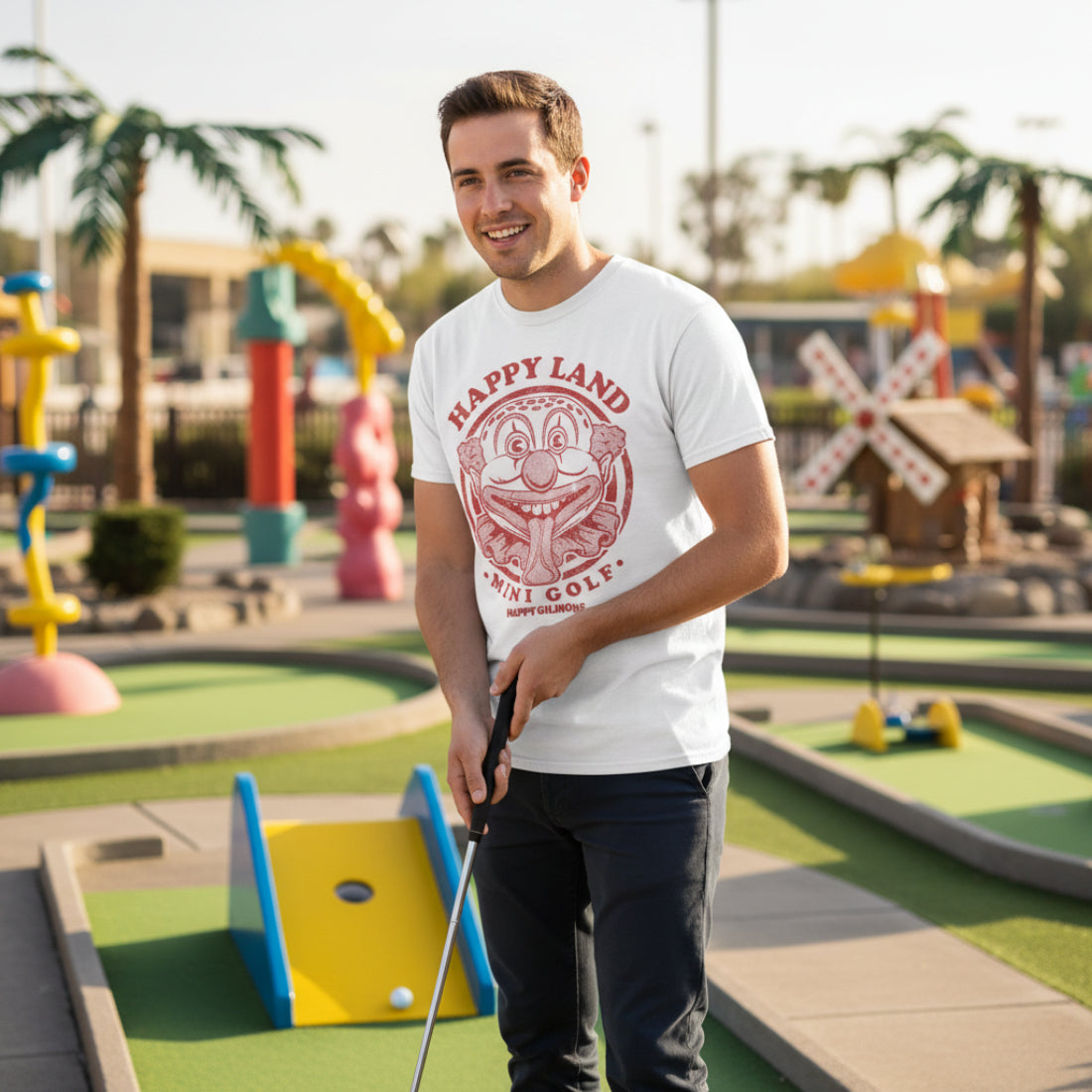 MAN WEARING White HAPPY GILMORE  t-shirt with red clown graphic and text 'Happy Land Mini Golf' HGIL546S, HGIL546M, HGIL546L, HGIL546XL, HGIL546XXL, HGIL546XXXL, HGIL546XXXXL, HGIL546XXXXXL
