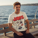 Man wearing Beige t-shirt with 'JAWS' graphic design featuring a shark, anchor, and ship JAW5567S, JAW5567M, JAW5567L, JAW5567XL, JAW5567XXL, JAW5567XXXL, JAW5567XXXXL