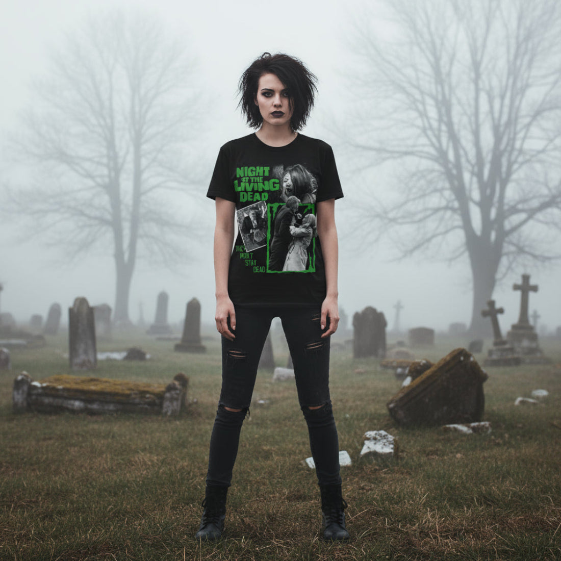 Goth woman wearing Black t-shirt with 'Night of the Living Dead' graphic design featuring a woman and a man in a green frame. NLD511S, NLD511M, NLD511L, NLD511XL, NLD511XXL, NLD511XXXL, NLD511XXXXL, NLD511XXXXXL