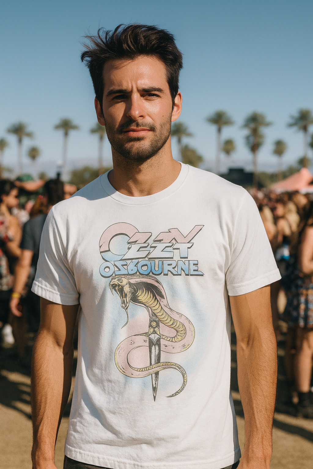 Man wearing a white t-shirt with Ozzy Osbourne logo at a music festival. OZZY516S, OZZY516M, OZZY516L, OZZY516XL, OZZY516XXL, OZZY516XXXL, OZZY516XXXXL, OZZY516XXXXXL