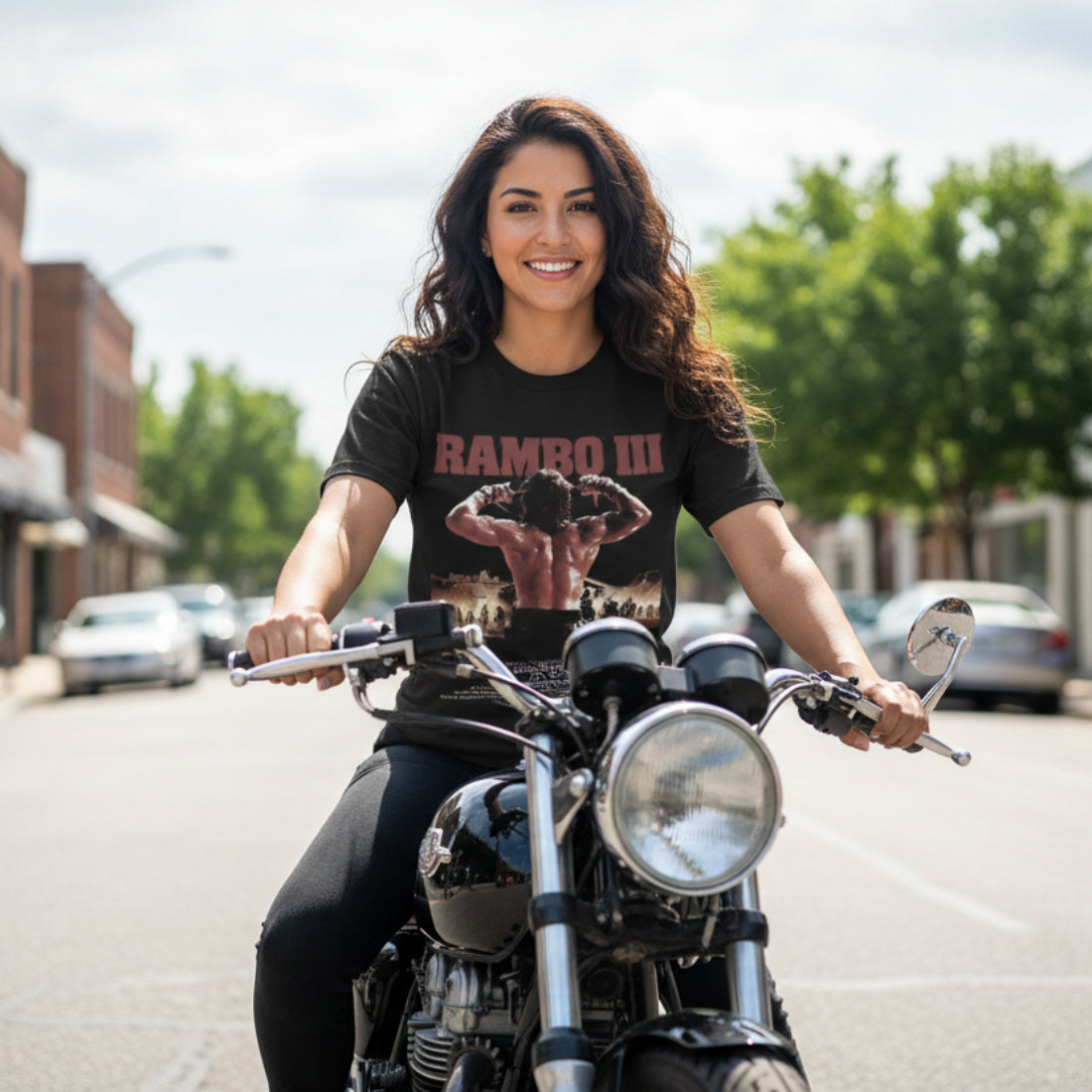 Woman riding a motorcycle wearing a 'Rambo III' t-shirt on a street. RAM5110S, RAM5110M, RAM5110L, RAM5110XL, RAM5110XXL, RAM5110XXXL, RAM5110XXXXL, RAM5110XXXXXL