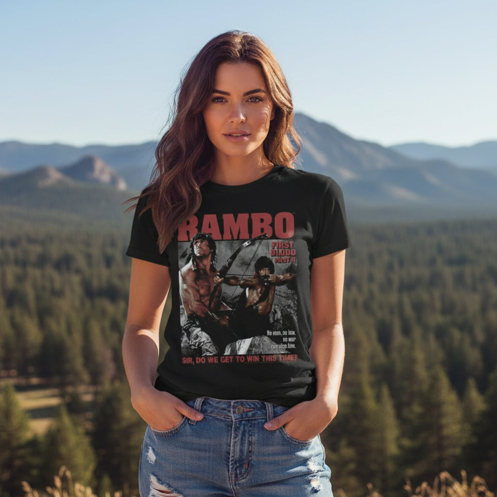 WOMAN WEARING Black t-shirt with 'Rambo' graphic design featuring a archer and text. RAM5111S, RAM5111M, RAM5111L, RAM5111XL, RAM5111XXL, RAM5111XXXL, RAM5111XXXXL, RAM5111XXXXXL