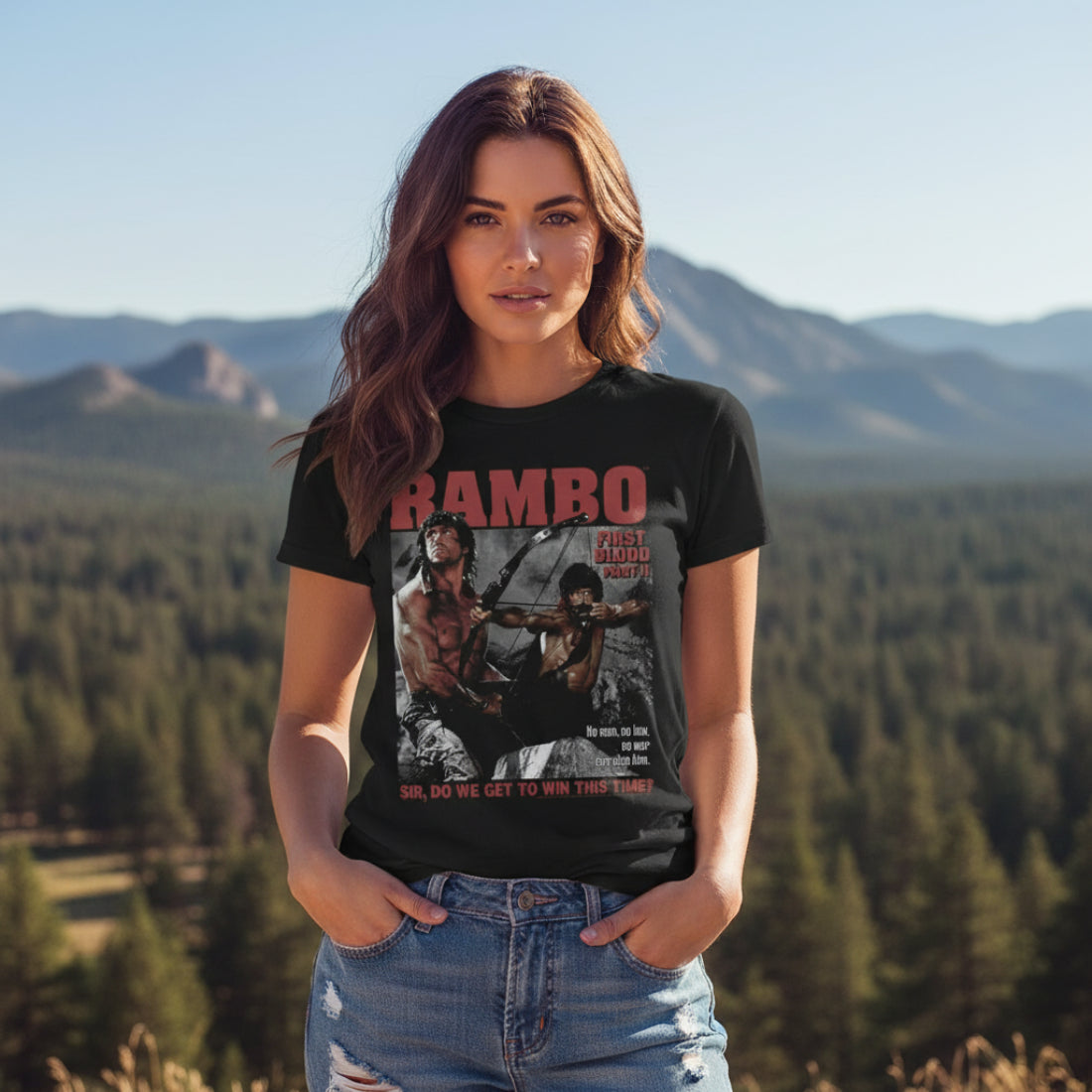 WOMAN WEARING Black t-shirt with 'Rambo' graphic design featuring a archer and text. RAM5111S, RAM5111M, RAM5111L, RAM5111XL, RAM5111XXL, RAM5111XXXL, RAM5111XXXXL, RAM5111XXXXXL