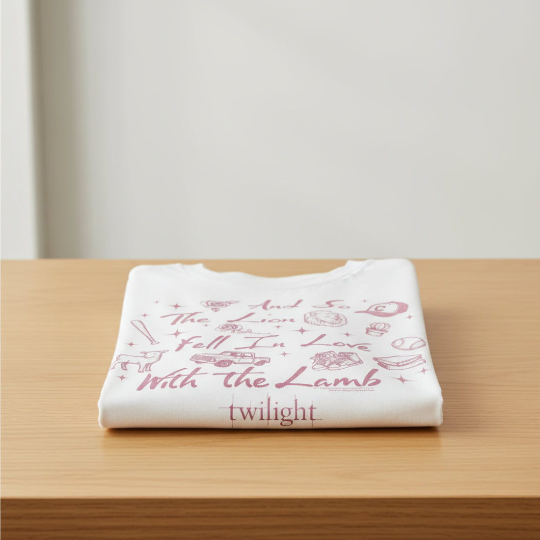 White t-shirt with pink text and graphics on a white background folded on a table. TWI5140S, TWI5140M, TWI5140L, TWI5140XL, TWI5140XXL, TWI5140XXXL, TWI5140XXXXL, TWI5140XXXXXL