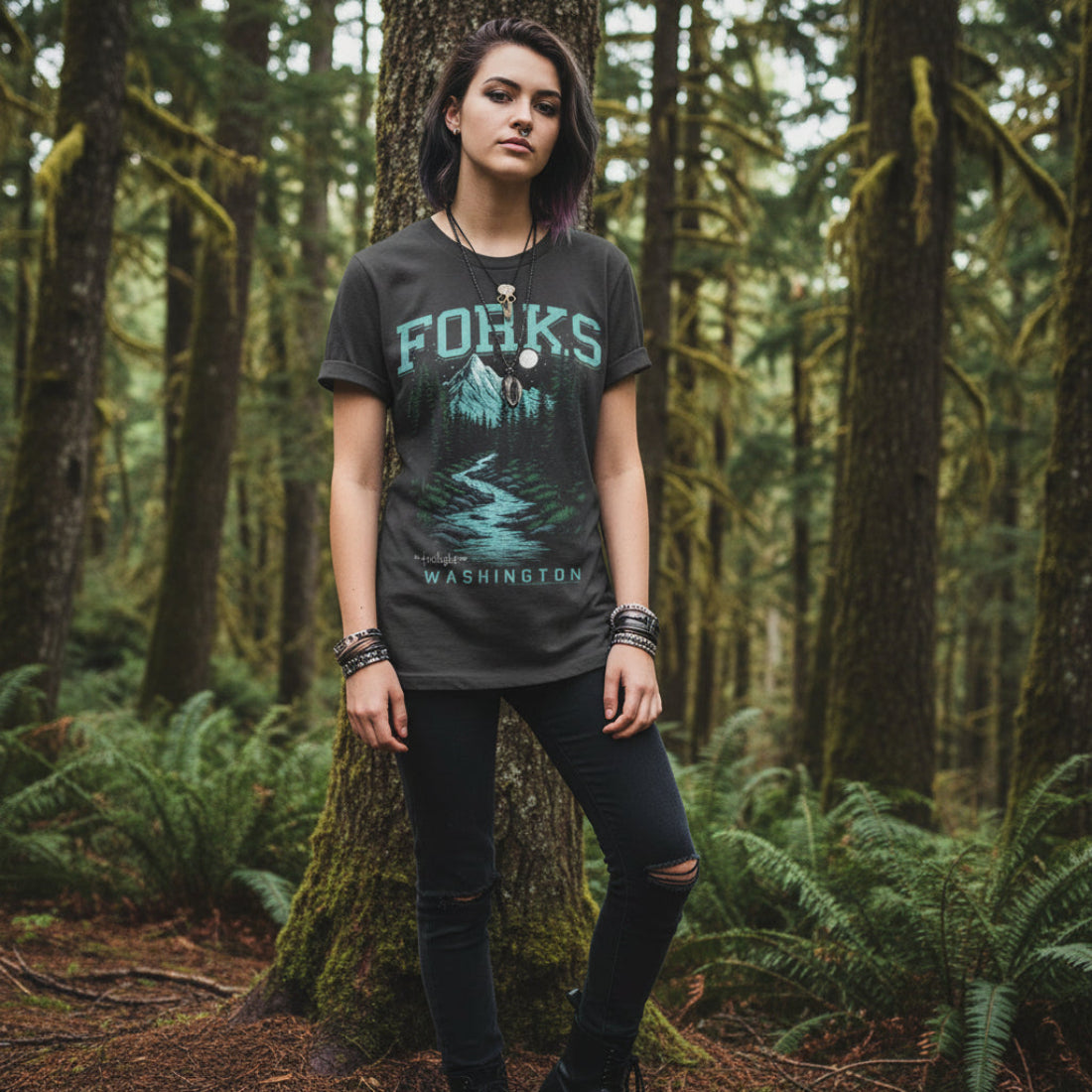 PERSON WEARING Black t-shirt with 'Forks, Washington' graphic design featuring a mountain and trees. TWI5146S, TWI5146M, TWI5146L, TWI5146XL, TWI5146XXL