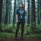 WOMAN WEARING Black TWILIGHT SAGA t-shirt with 'Forks, Washington' graphic design featuring a mountain and trees. TWI5146S, TWI5146M, TWI5146L, TWI5146XL, TWI5146XXL