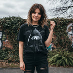 WOMAN WEARING Black t-shirt with 'Alice in Chains' graphic design featuring an eye and cross. AIC519S, AIC519M, AIC519L, AIC519XL, AIC519XXL, AIC519XXXL, AIC519XXXXL, AIC519XXXXXL