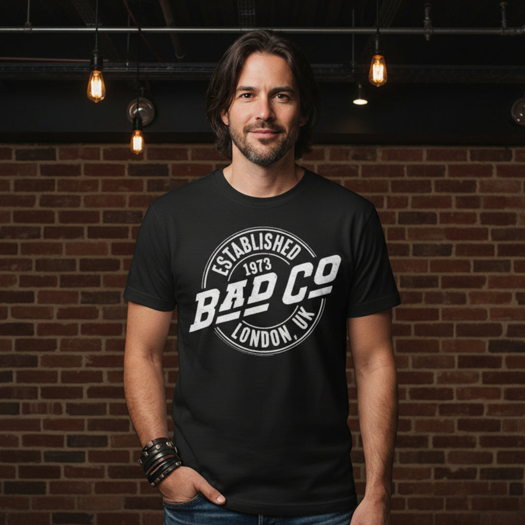 MAN WEARING Black t-shirt with 'Bad Co' logo on a white background BCO501S, BCO501M, BCO501L, BCO501XL, BCO501XXL, BCO501XXXL, BCO501XXXXL, BCO501XXXXXL