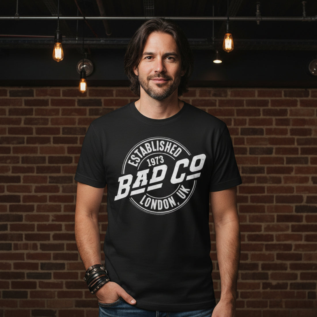 MAN WEARING Black t-shirt with 'Bad Co' logo on a white background BCO501S, BCO501M, BCO501L, BCO501XL, BCO501XXL, BCO501XXXL, BCO501XXXXL, BCO501XXXXXL